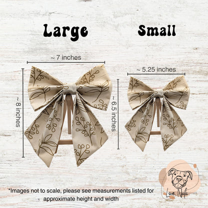 Two pet sailor bows with measurements labeled for large and small sizes on a wooden background.