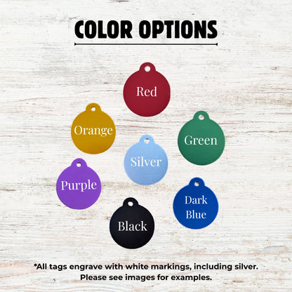 Color options for engraved tags displayed on a wooden surface.