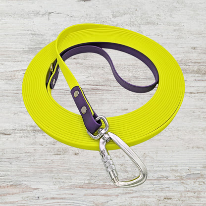 Highlighter yellow long line dog leash with purple handle and silver carabiner.
