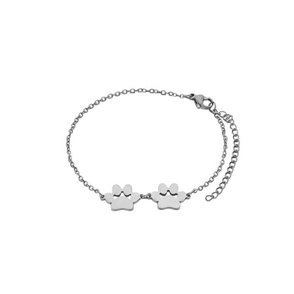 Silver bracelet with paw print charms on a white background