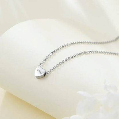 Silver necklace with a heart-shaped pendant on a white background